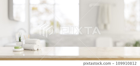 A white tabletop with a copy space and a blurred background of a modern bright bathroom. 109910812