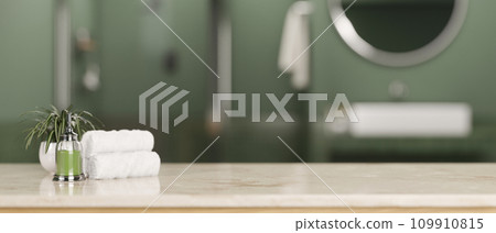 A tabletop with bath accessories and a blurred background of a modern green bathroom. A tabletop with bath accessories and a blurred background of a modern green bathroom. 109910815