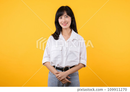 Pretty businesswoman. asian woman enterpriser happy smile wearing white shirt and denim plants with confident and smart looking isolation on yellow background. advertising product and service concept. Pretty businesswoman. asian woman enterpriser happy smile wearing white shirt and denim plants with confident and smart looking isolation on yellow background. advertising product and service concept. 109911270