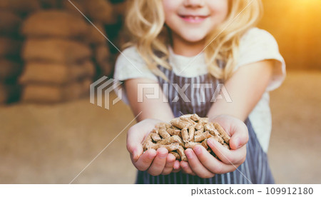 Seeds of Sustainability: Children's Hands Embrace Wood Pellets 109912180