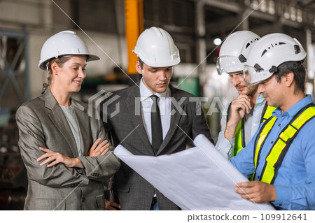 group of industry people engineer brainstorm team builder architect and technician talking consulting together in site building for renovation planning with floor plan together. 109912641