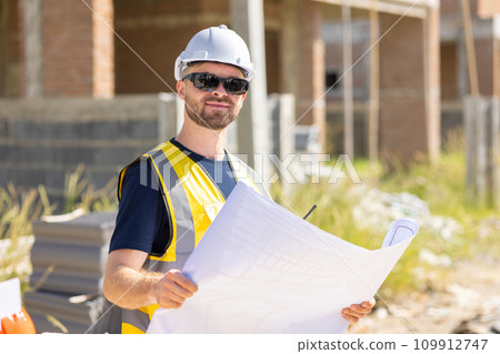 Professional construction worker engineer male. Real estate house project builder. Smart architect man standing work in construction site. 109912747