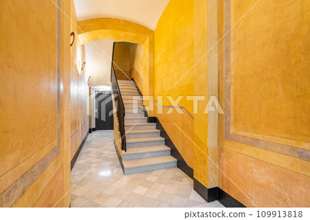 Stairs in yellow-walled hallway at entrance of building Stairs in yellow-walled hallway at entrance of building 109913818