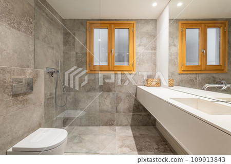 Large bathroom with long vanity unit near washbasin area Large bathroom with long vanity unit near washbasin area 109913843