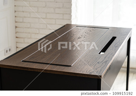 Mobile phone with wireless charger on table. Modern workplace accessory 109915192