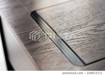 Mobile phone with wireless charger on table. Modern workplace accessory 109915311