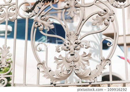 Image of a Beautiful decorative cast iron wrought fence with artistic forging. Metal guardrail close up. 109916292