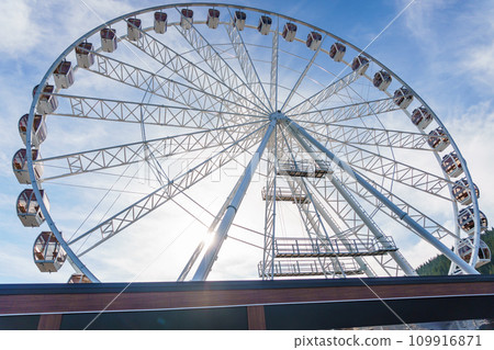 Big tall white ferris wheel in front of perfect blue sky in Bukovel. Carpathians Ukraine Big tall white ferris wheel in front of perfect blue sky in Bukovel. Carpathians Ukraine 109916871