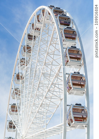 Big tall white ferris wheel in front of perfect blue sky in Bukovel. Carpathians Ukraine Big tall white ferris wheel in front of perfect blue sky in Bukovel. Carpathians Ukraine 109916884