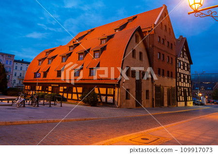 2022-07-07 Ancient medieval building of water mill and granary at dusk . Bydgoszcz, Poland 109917073