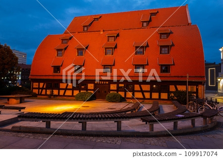 2022-07-07 Ancient medieval building of water mill and granary at dusk . Bydgoszcz, Poland 109917074