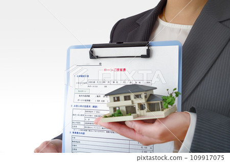 A woman with a mortgage estimate and a model A woman with a mortgage estimate and a model 109917075