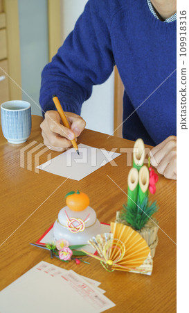 Image of a man writing a New Year's card Image of a man writing a New Year's card 109918316