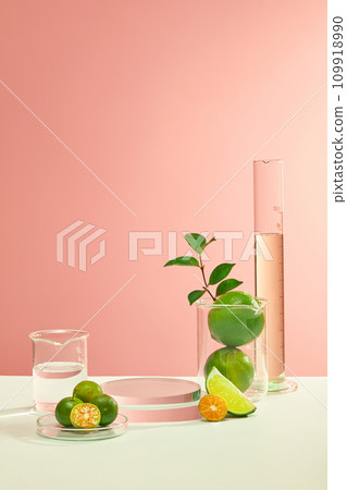 Fresh lemons and glassware arranged on a white table against a pink background, creating an ideal setting for promoting natural cosmetics enriched with the vitamin C goodness of lemons. Fresh lemons and glassware arranged on a white table against a pink background, creating an ideal setting for promoting natural cosmetics enriched with the vitamin C goodness of lemons. 109918990