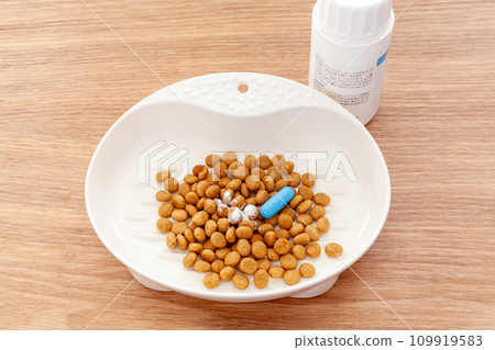 Mix pet supplements with cat food 109919583