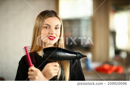Girl Hairdresser Crossed Hands with Comb and Dryer 109920096
