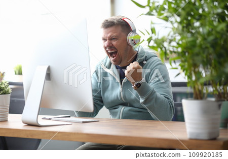 Man screaming in computer monitor sitting Man screaming in computer monitor sitting 109920185