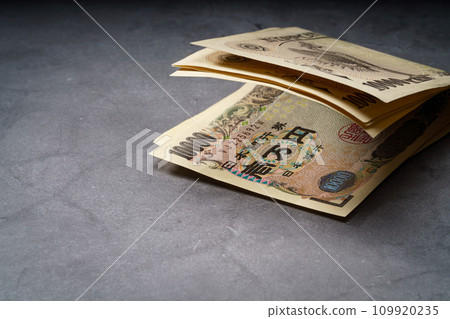 banknotes on dark background 109920235