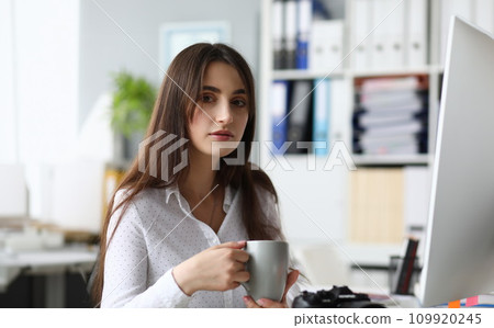 Pretty businesslady holding cup Pretty businesslady holding cup 109920245
