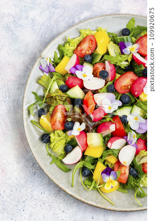 Vegetable salad decorated with flowers. 109920675