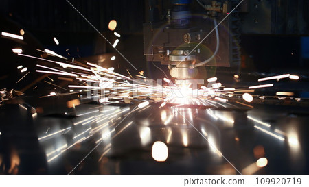 Laser metall cut cnc machine. Fly fire sparks background. 109920719
