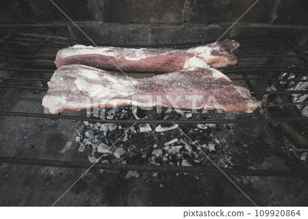 Raw meat put on the grill, traditional Argentine cuisine, Asado barbecue, Patagonia, Argentina. 109920864