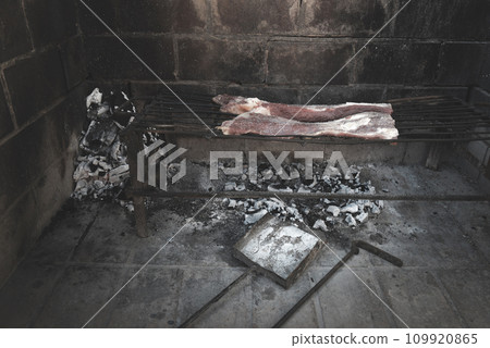 Raw meat put on the grill, traditional Argentine cuisine, Asado barbecue, Patagonia, Argentina. 109920865