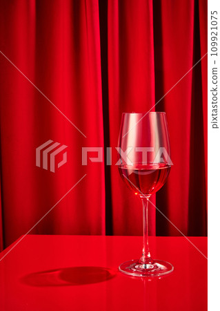 Close up photo of sweet red, pink seasoned wine served in high glass classy on bar counter at restaurant. Concept of Valentines day, alcohol. 109921075