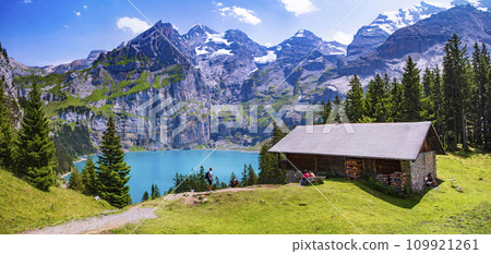 Idyllic swiss mountain lake Oeschinensee (Oeschinen) with turquise water and snowy peaks of Alps mountains near Kandersteg village. Switzerland nature and travel 109921261