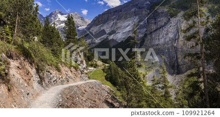 Idyllic swiss  scenery with snowy peaks of Alps mountains near Kandersteg village . Hiking route to Oeschinensee lake.  Switzerland nature 109921264