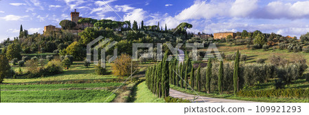 landscape of Italian countryside, romantic Tuscany scenery with cypresses and castles. famous region Val d'orcia, Italy. landscape of Italian countryside, romantic Tuscany scenery with cypresses and castles. famous region Val d'orcia, Italy. 109921293