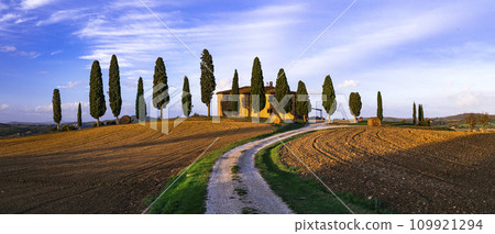 Italy, romantic Tuscany scenery with traditional cypresses and rolling hills. famous region Val d'orcia. Italy, romantic Tuscany scenery with traditional cypresses and rolling hills. famous region Val d'orcia. 109921294