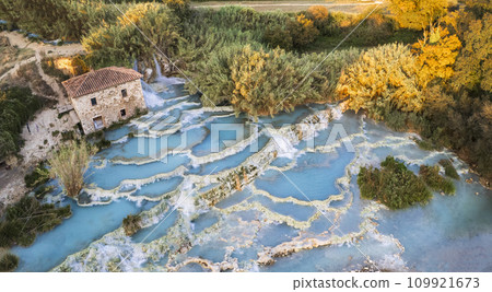 Most famous natural thermal hot spings pools in Tuscany -  scenic Terme di Mulino vecchio ( Thermals of Old Windmill) in Grosseto province. Aerial drone view 109921673