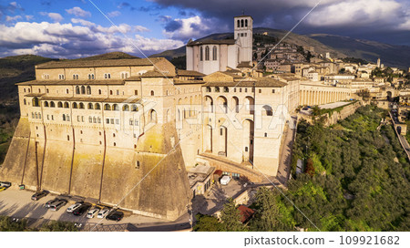 Italy . Impressive medieval Assisi town in Umbria and religious landmark. aerial drone panoramic view. italian travel and best destinations Italy . Impressive medieval Assisi town in Umbria and religious landmark. aerial drone panoramic view. italian travel and best destinations 109921682