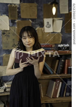 Young woman reading in a chic room Young woman reading in a chic room 109923570