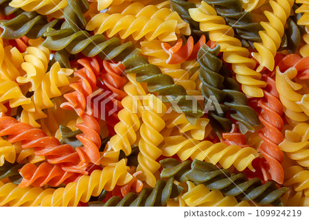 Uncooked Vibrant Colored Fusilli Pasta Background 109924219