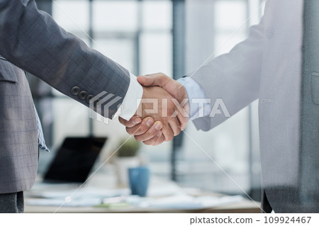 Businessman handshake for teamwork of business merger and acquisition Businessman handshake for teamwork of business merger and acquisition 109924467