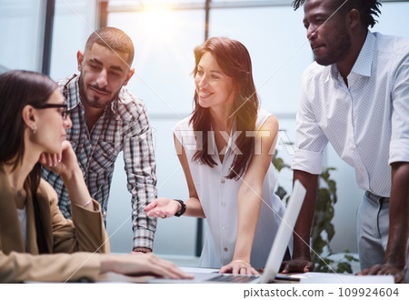 Happy young female worker discussing online project, showing presentation to experienced team leader in glasses. 109924604