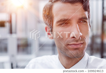 close-up, portrait of a serious businessman on the background of the office close-up, portrait of a serious businessman on the background of the office 109924613