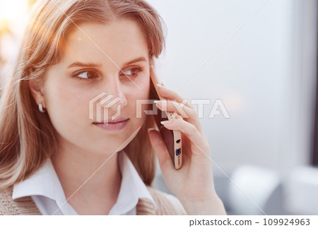 Young charming woman calling with cell telephone Young charming woman calling with cell telephone 109924963