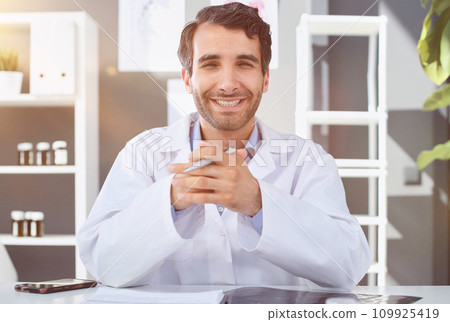 Portrait confident male doctor working in clinic doctors office 109925419