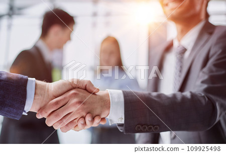 Close up of a handshake against college hallway Close up of a handshake against college hallway 109925498