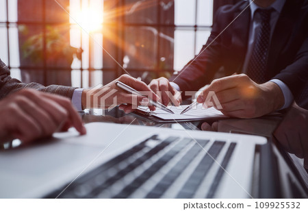 man's hands typing on laptop keyboard in interior 109925532