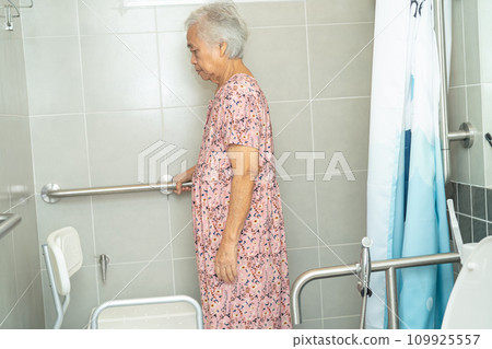 Asian elderly woman patient use toilet bathroom handle security in nursing hospital, healthy strong medical concept. 109925557