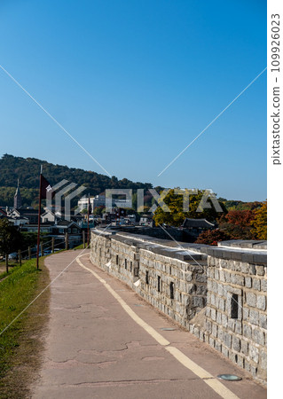 Suwon Hwaseong Fortress Wall, with the park view during autumn. The wall is surrounding the center of Suwon, the provincial capital of Gyeonggi-do, in South Korea 109926023