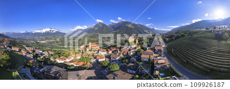 Tourism of northern Italy. Traditional picturesque mountain village Schenna (Scena) near Merano town in Trentino - Alto Adige region. view of medieval castle, aerial  panoramic drone view 109926187