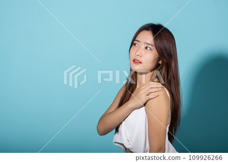 Portrait female raising arm and hand in protection and block sunshine, young woman hand up cover face protect sun light and UV in studio isolated on blue background, cosmetic sunscreen cream advertise 109926266