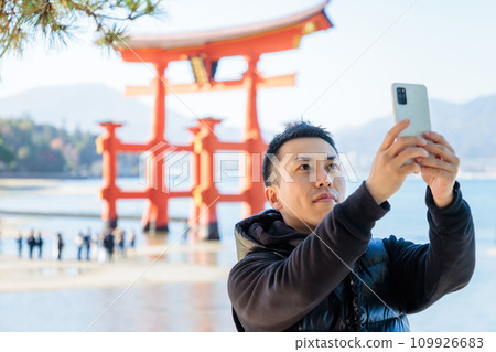 Young man taking a selfie at a tourist spot Young man taking a selfie at a tourist spot 109926683