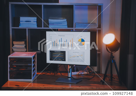 Team of software developers working on big project late at night in neon light trying to finish before deadline 109927148