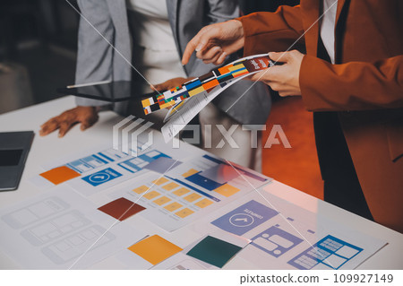 team of UI UX web designer are working together to develop mobile responsive websites. Mobile Mockup team of UI UX web designer are working together to develop mobile responsive websites. Mobile Mockup 109927149